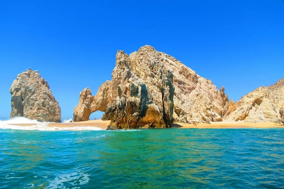 El Arco, the granite rock arch at Land's End in Cabo San Lucas, with waves breaking on the beach between the rock formations