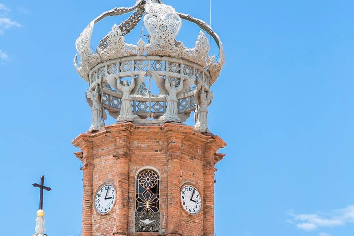The crowned bell tower of Our Lady of Guadalupe cathedral in downtown Puerto Vallarta against a clear sky